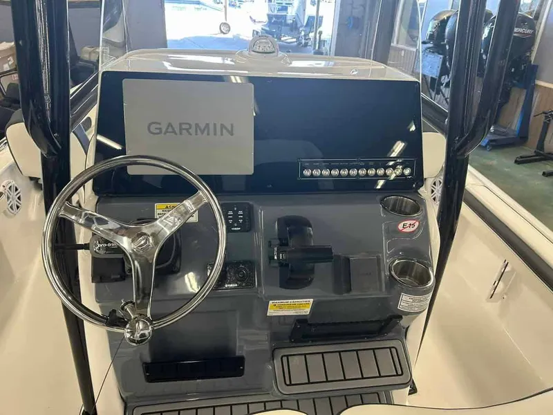 Slide: The Image of 2024 Tidewater 2300 Carolina Bay boat console with Garmin display and steering wheel. - 10