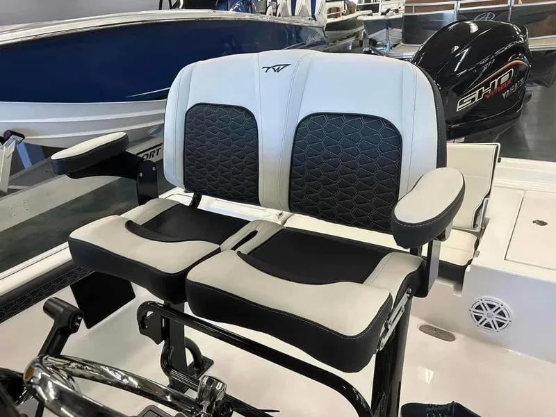 Slide: The Image of 2024 Tidewater 2300 Carolina Bay boat seats with black and white upholstery in showroom. - 12