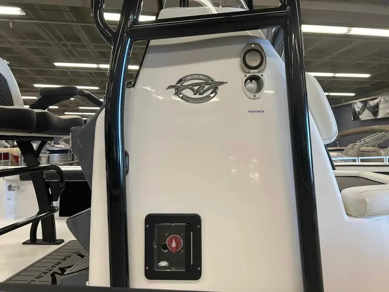 Slide: The Image of 2024 Tidewater 2300 Carolina Bay boat interior with control panel and seating. - 7