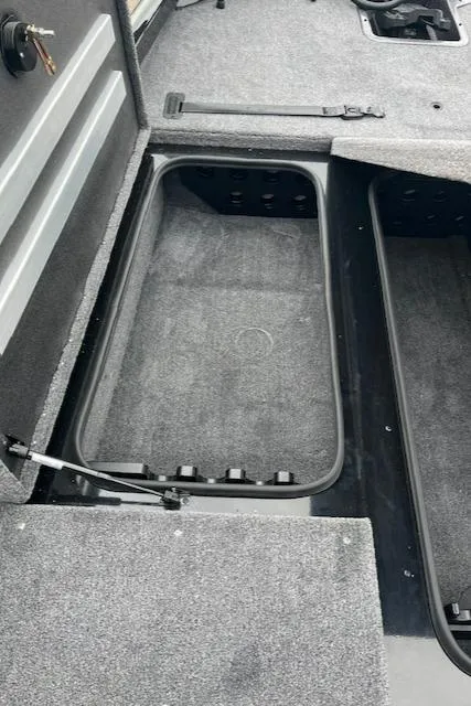 Slide: The Image of 2024 Ranger RT188P boat storage compartments with grey carpeting. - 12