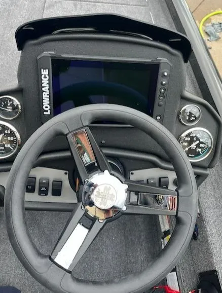 Slide: The Image of 2024 Ranger RT188P boat dashboard with Lowrance display and steering wheel. - 2