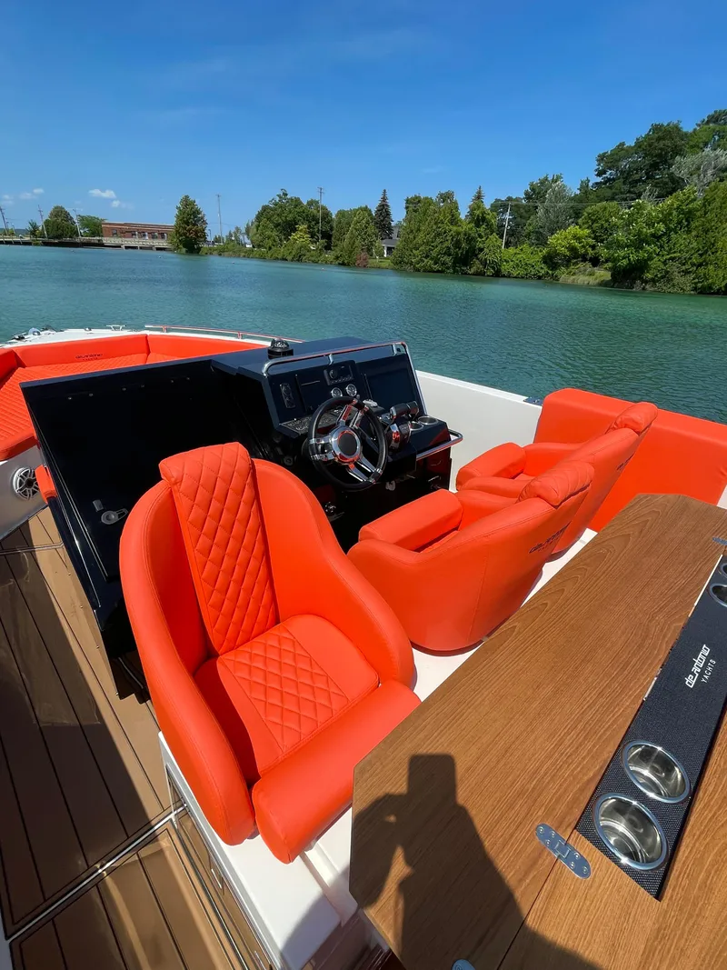 Slide: The Image of 2020 De Antonio Yachts D 28 with red seats on a scenic lake. - 11