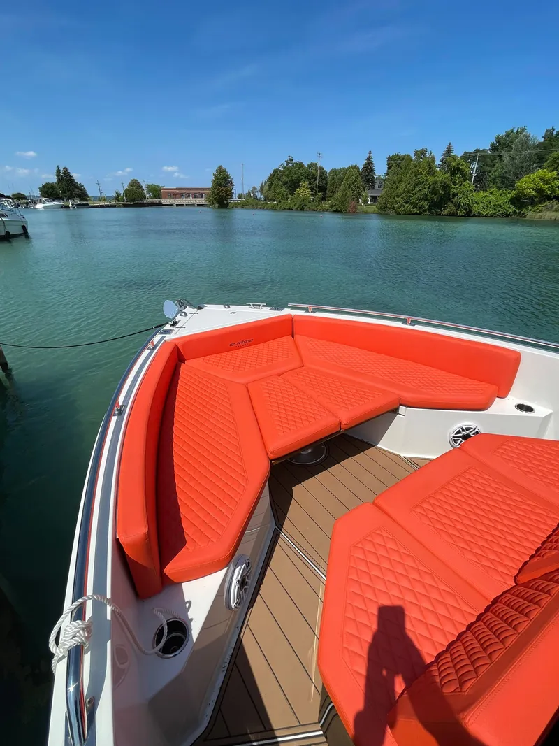 Slide: The Image of De Antonio Yachts D 28 (2020) with vibrant orange seating on a serene lake. - 13