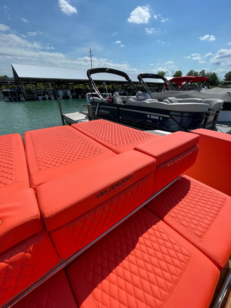 Slide: The Image of De Antonio Yachts D 28 2020 model with red quilted seating at a marina. - 19