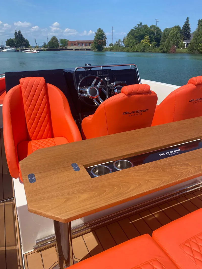 Slide: The Image of 2020 De Antonio Yachts D 28 with orange seating and wooden table on a sunny day. - 23