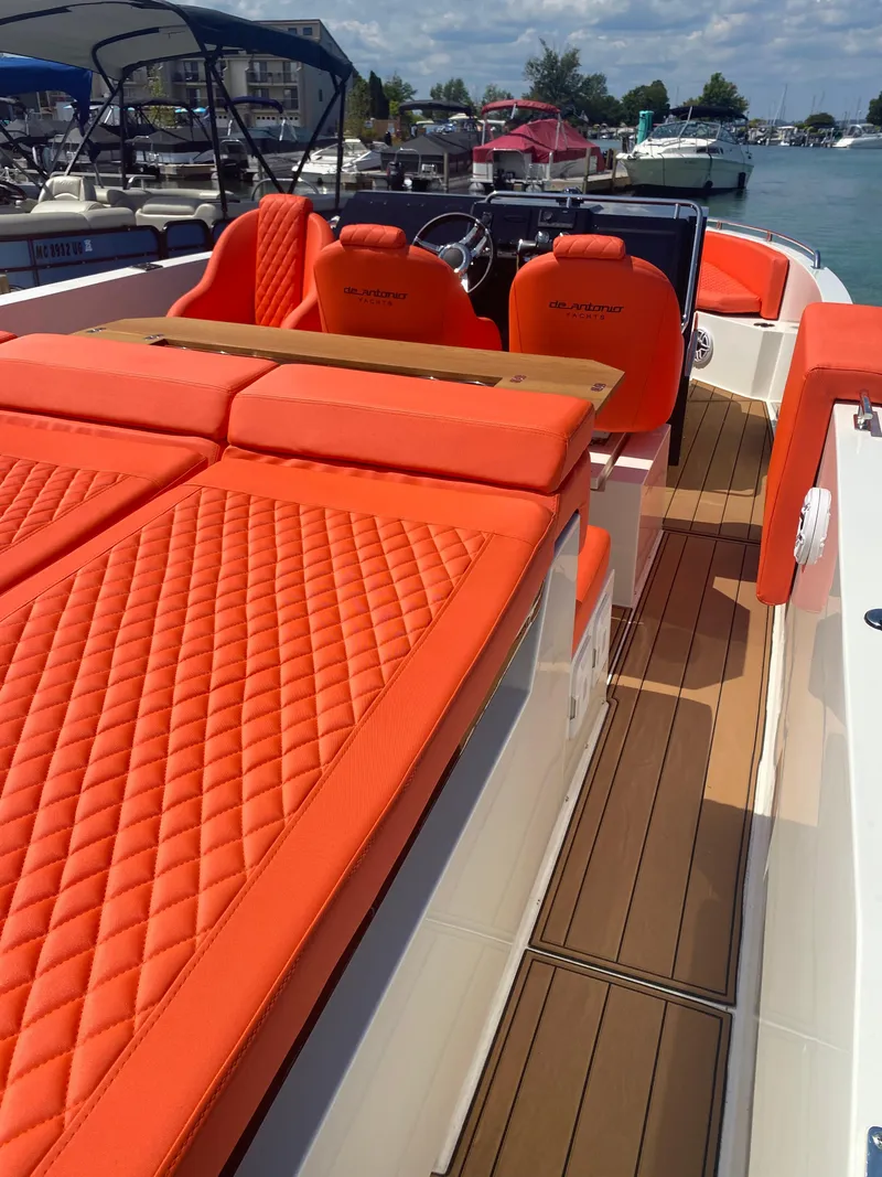 Slide: The Image of 2020 De Antonio Yachts D 28 with vibrant orange seating and sleek deck design. - 37