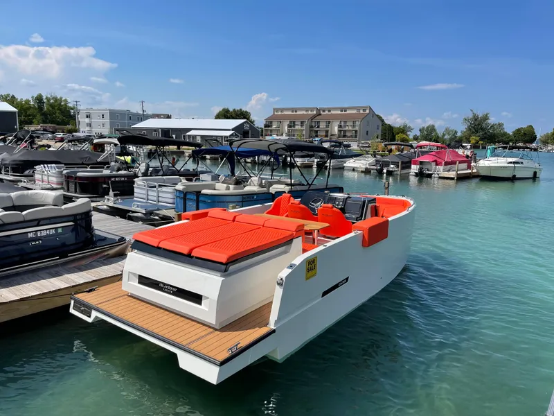 Slide: The Image of 2020 De Antonio Yachts D 28 docked in a marina with vibrant orange seating. - 4