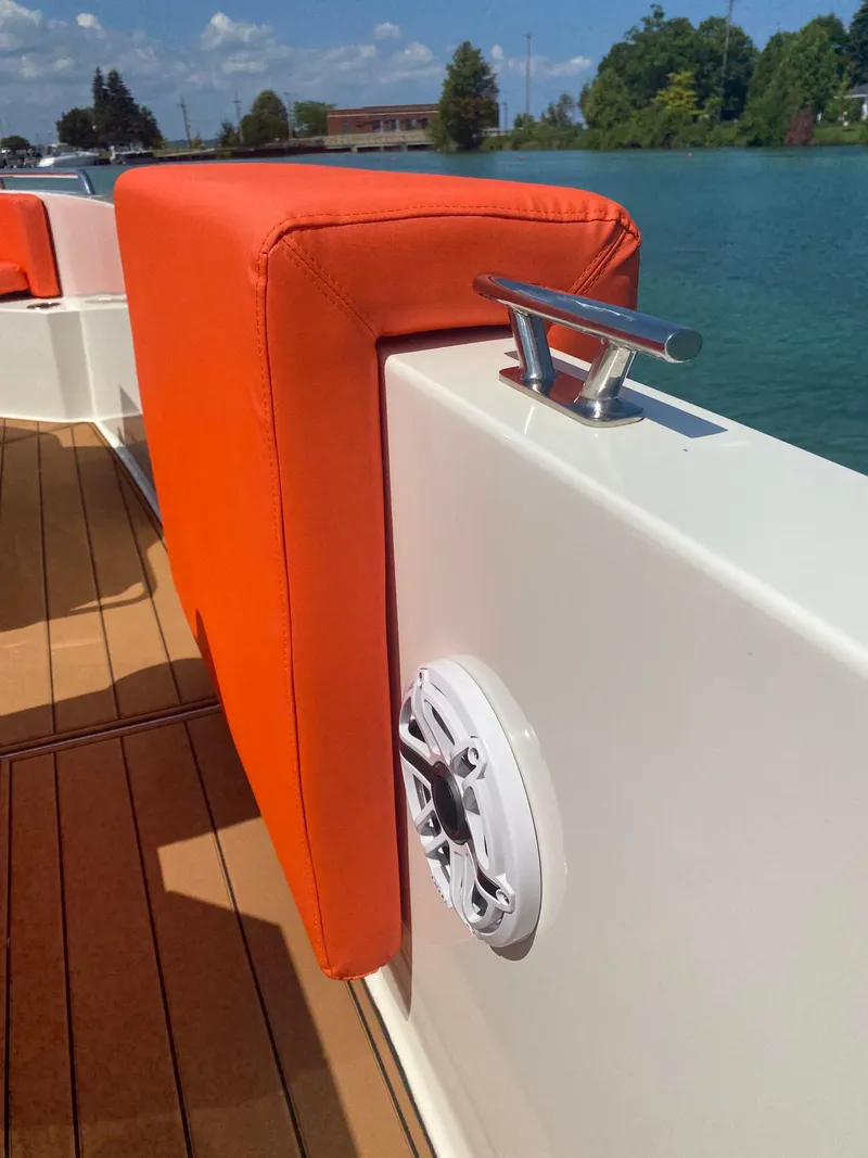 Slide: The Image of De Antonio Yachts D 28 (2020) with orange seating, dock cleat, and speaker on deck. - 41