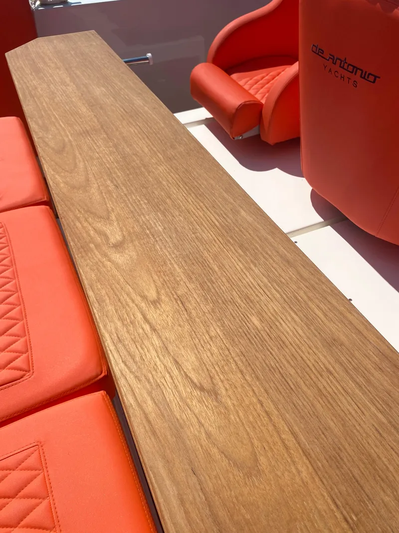 Slide: The Image of De Antonio Yachts D 28 2020 model with wooden table and red seating. - 43
