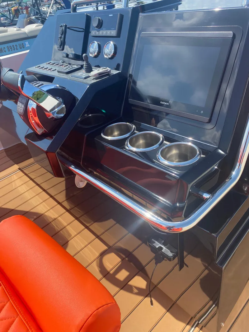 Slide: The Image of Control panel of 2020 De Antonio Yachts D 28 with navigation screen and cup holders. - 49