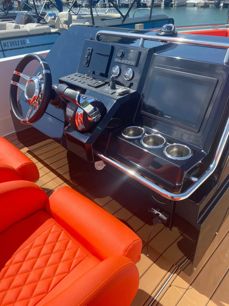 Slide: The Image of Control panel of 2020 De Antonio Yachts D 28 with red seating and modern dashboard. - 50