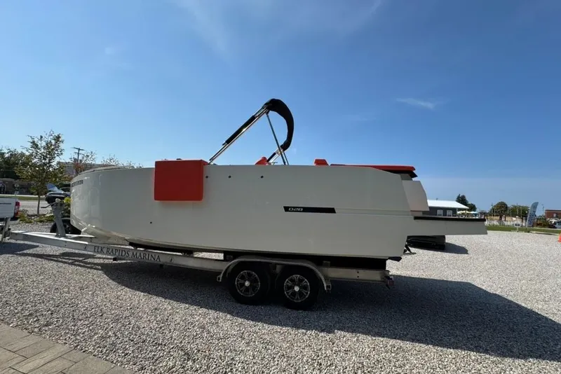 Slide: The Image of 2020 De Antonio Yachts D28 on trailer at Elk Rapids Marina under clear blue sky. - 60