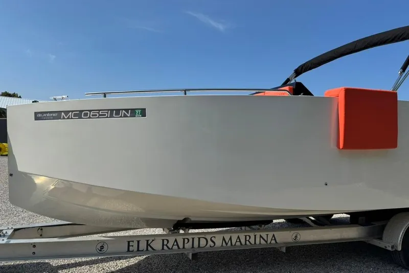 Slide: The Image of 2020 De Antonio Yachts D28 on trailer at Elk Rapids Marina under clear blue sky. - 61