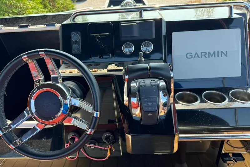 Slide: The Image of Helm of 2020 De Antonio Yachts D28 featuring Garmin navigation system and modern controls. - 66