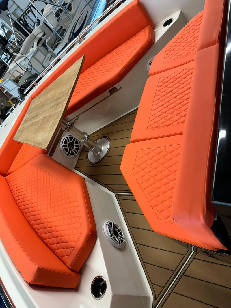 Slide: The Image of De Antonio Yachts D 28 2020 model with orange seating and wooden table. - 7