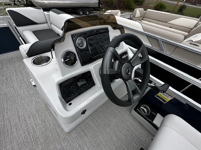 Slide: The Image of 2024 Tahoe Pontoon SPORT 2180 QL boat dashboard and steering wheel. - 3