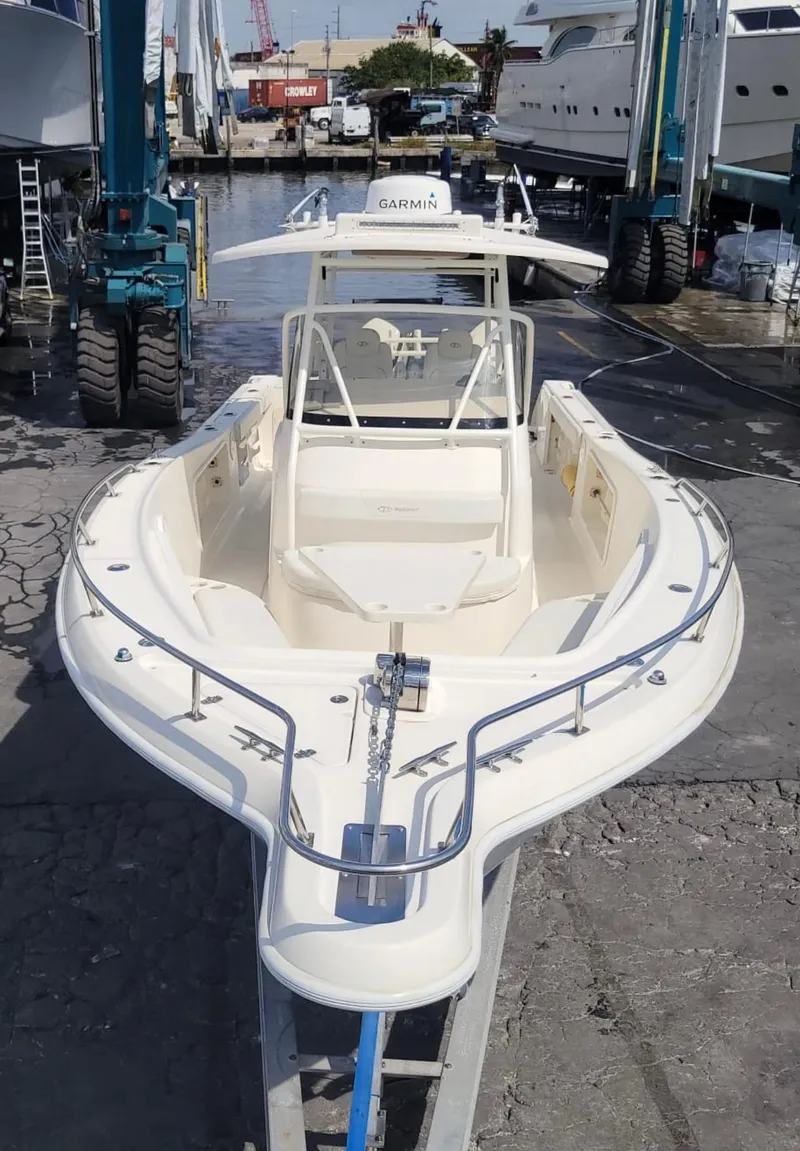 Slide: The Image of 2002 Pursuit 3070 Center Console boat in a marina. - 2