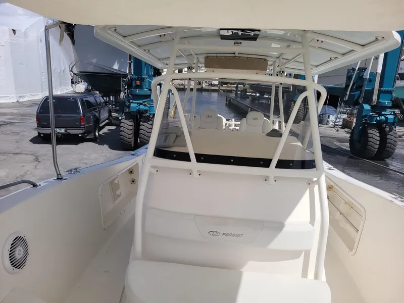 Slide: The Image of 2002 Pursuit 3070 Center Console boat at a marina. - 4