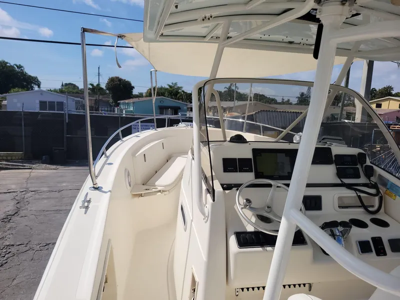 Slide: The Image of 2002 Pursuit 3070 Center Console boat with steering wheel and navigation equipment. - 6