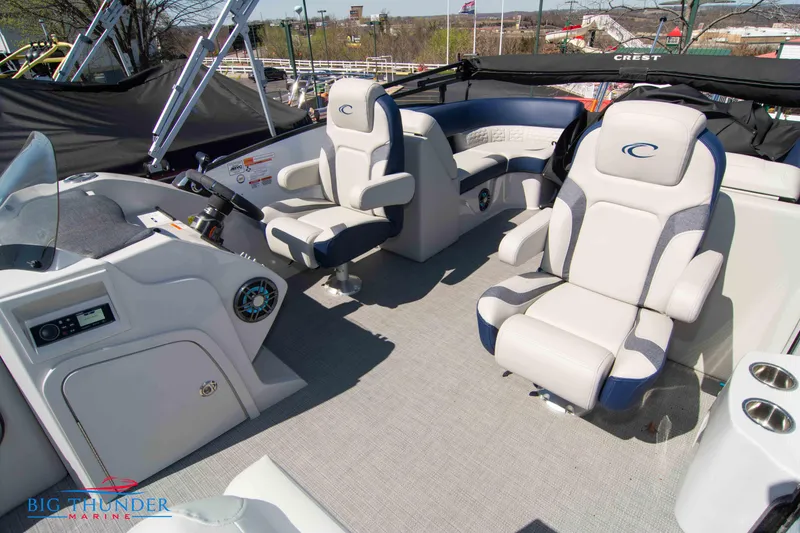 Slide: The Image of 2023 Crest Caribbean LX 250 SLC boat interior with plush seating and modern dashboard. - 10