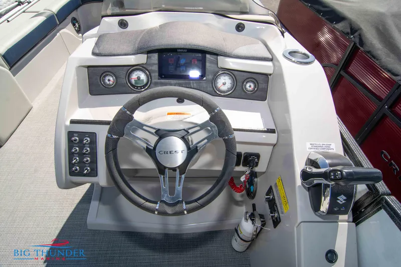 Slide: The Image of 2023 Crest Caribbean LX 250 SLC boat dashboard with steering wheel and control panel. - 12