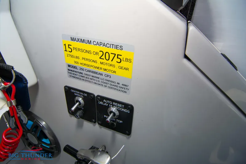 Slide: The Image of 2023 Crest Caribbean LX 250 SLC capacity label and control switches. - 18