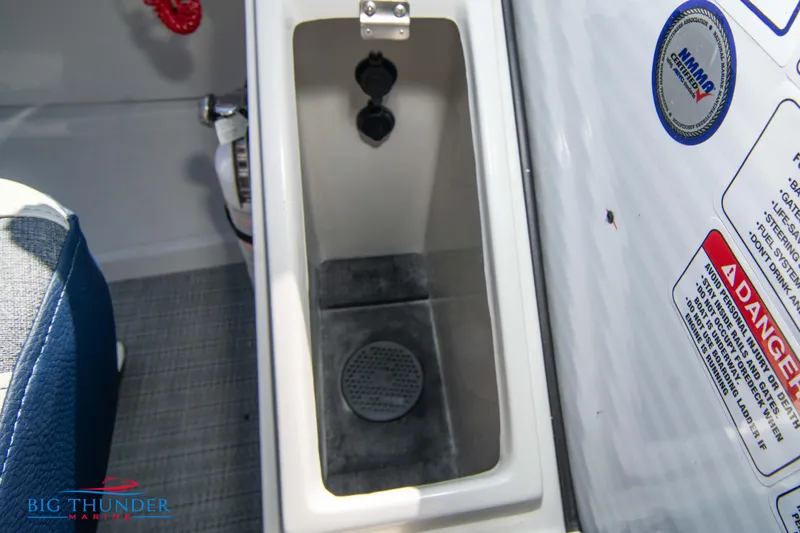Slide: The Image of 2023 Crest Caribbean LX 250 SLC boat storage compartment with safety labels. - 19