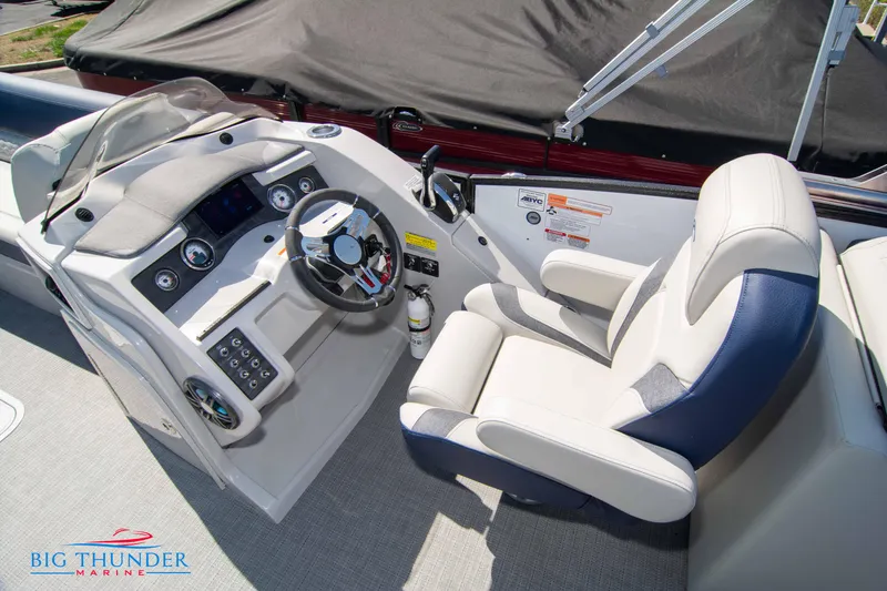 Slide: The Image of 2023 Crest Caribbean LX 250 SLC boat helm with captain's chair and control panel. - 21