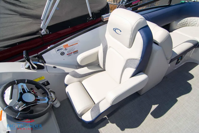 Slide: The Image of 2023 Crest Caribbean LX 250 SLC boat interior with captain's chair and steering wheel. - 22