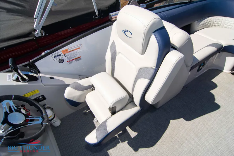 Slide: The Image of Captain's chair of 2023 Crest Caribbean LX 250 SLC boat with steering wheel and controls. - 23