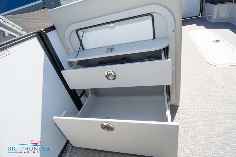 Slide: The Image of 2023 Crest Caribbean LX 250 SLC storage drawers on deck. - 25