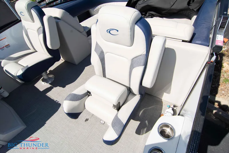 Slide: The Image of 2023 Crest Caribbean LX 250 SLC boat interior with plush seating and cup holders. - 27