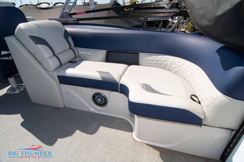 Slide: The Image of 2023 Crest Caribbean LX 250 SLC boat interior seating with blue and white upholstery. - 29