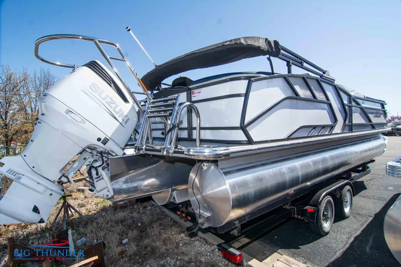 Slide: The Image of 2023 Crest Caribbean LX 250 SLC pontoon boat on a trailer with Suzuki outboard motor. - 3