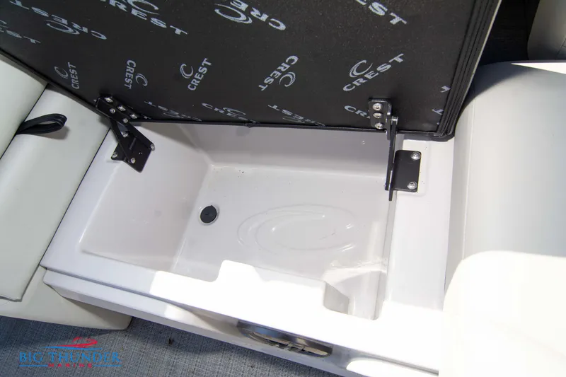 Slide: The Image of 2023 Crest Caribbean LX 250 SLC storage compartment with open lid. - 32