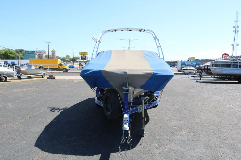 Slide: The Image of 2007 Tahoe Q6 SF boat with cover on trailer in parking lot. - 15