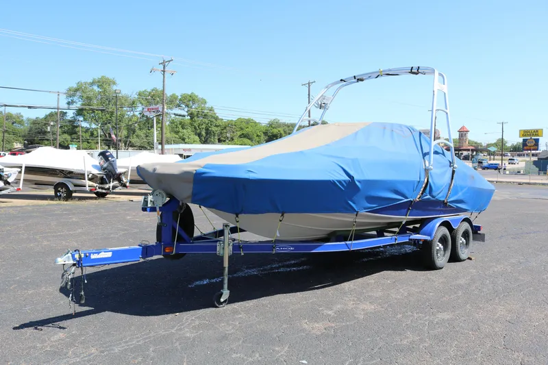 Slide: The Image of 2007 Tahoe Q6 SF boat on a trailer, covered with a blue tarp. - 16