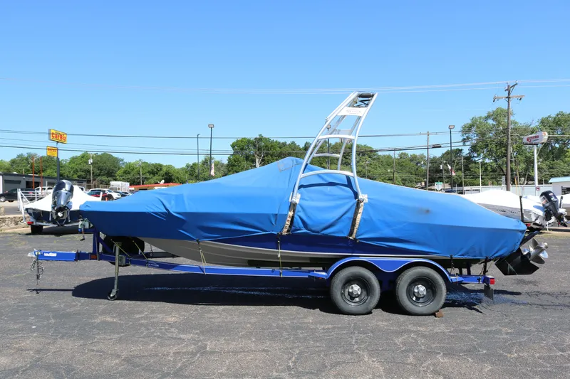 Slide: The Image of 2007 Tahoe Q6 SF boat with blue cover on trailer. - 17