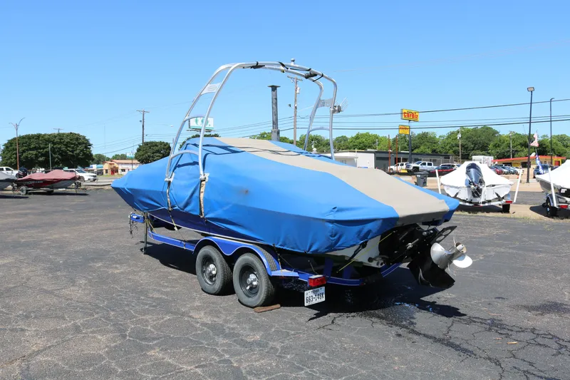 Slide: The Image of 2007 Tahoe Q6 SF boat with blue cover on trailer in parking lot. - 18