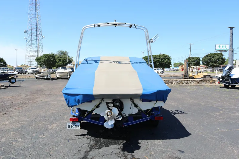Slide: The Image of 2007 Tahoe Q6 SF boat with blue and beige cover, rear view. - 19