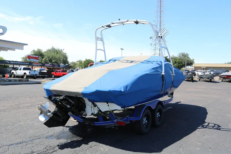 Slide: The Image of 2007 Tahoe Q6 SF boat with blue cover on trailer in parking lot. - 20