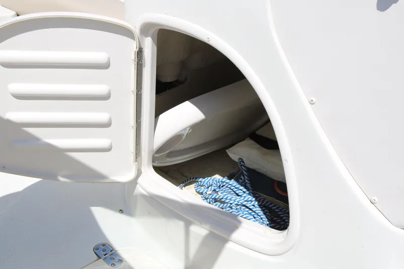 Slide: The Image of Open storage compartment on a 2007 Tahoe Q6 SF boat with blue rope inside. - 33