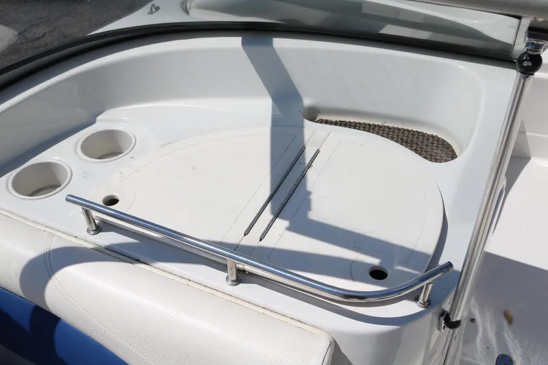 Slide: The Image of 2007 Tahoe Q6 SF boat interior with cup holders and storage compartment. - 34