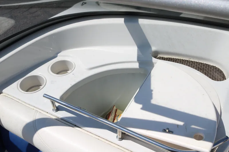 Slide: The Image of 2007 Tahoe Q6 SF boat interior with cup holders and storage compartment. - 36