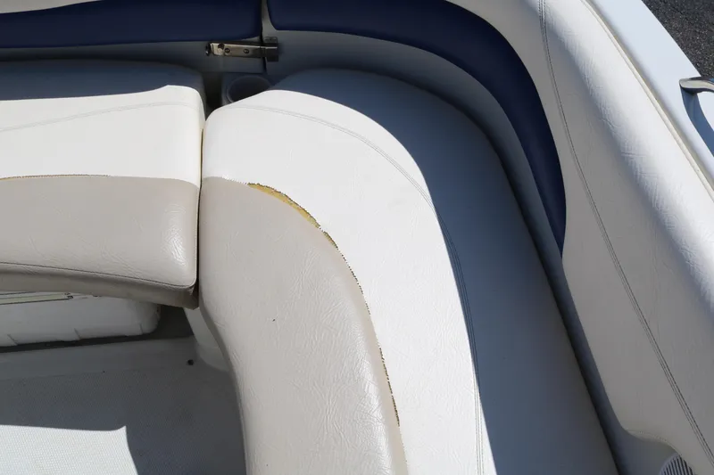 Slide: The Image of 2007 Tahoe Q6 SF boat interior with worn white and beige upholstery. - 38