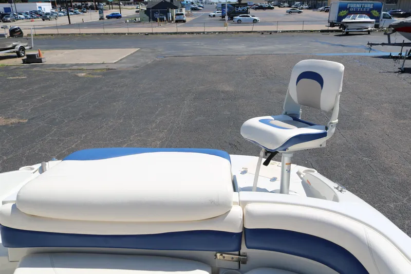 Slide: The Image of 2007 Tahoe Q6 SF boat with white and blue seating, parked on asphalt. - 39