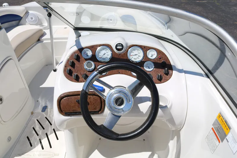 Slide: The Image of 2007 Tahoe Q6 SF boat dashboard with steering wheel and gauges. - 45