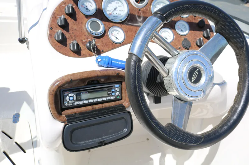 Slide: The Image of 2007 Tahoe Q6 SF boat dashboard with steering wheel and control panel. - 46