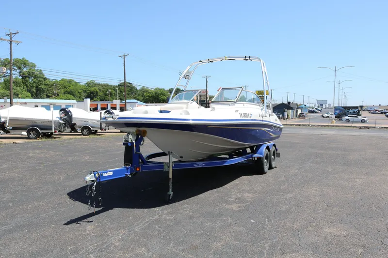 Slide: The Image of 2007 Tahoe Q6 SF boat on a trailer in a parking lot. - 5