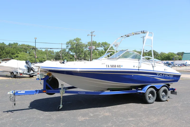 Slide: The Image of 2007 Tahoe Q6 SF boat on a trailer in a parking lot. - 6